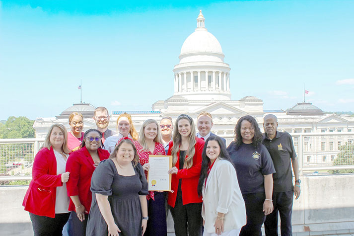 A-State's RESTORE, HOWL, and ATLAS staff pose with staff from 3D, UAPB, Southeast Community College, and Empower at the IPSE day proclamation signing